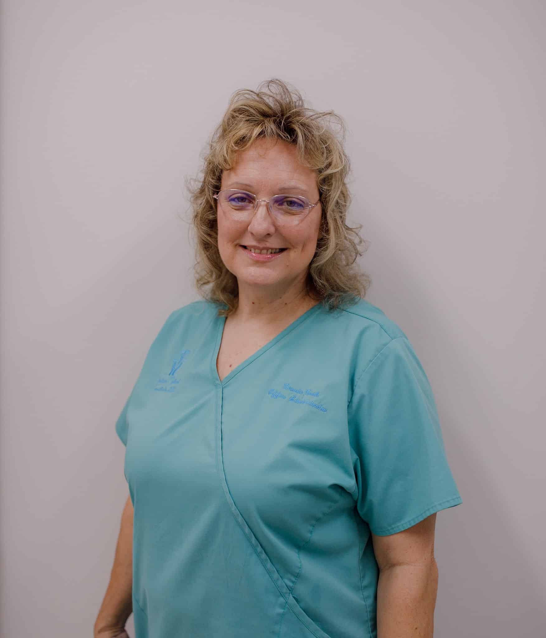 Smiling woman in blue medical scrubs