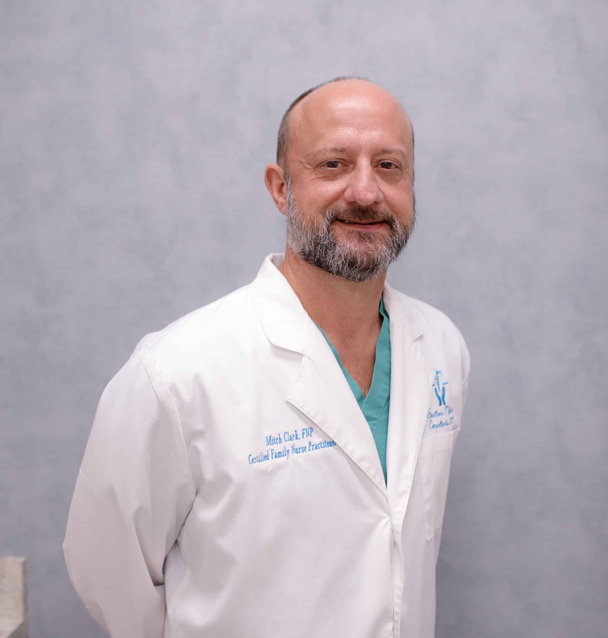Smiling healthcare professional in white coat.