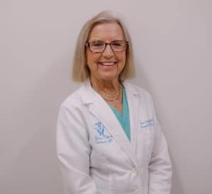 Smiling doctor in white coat and glasses