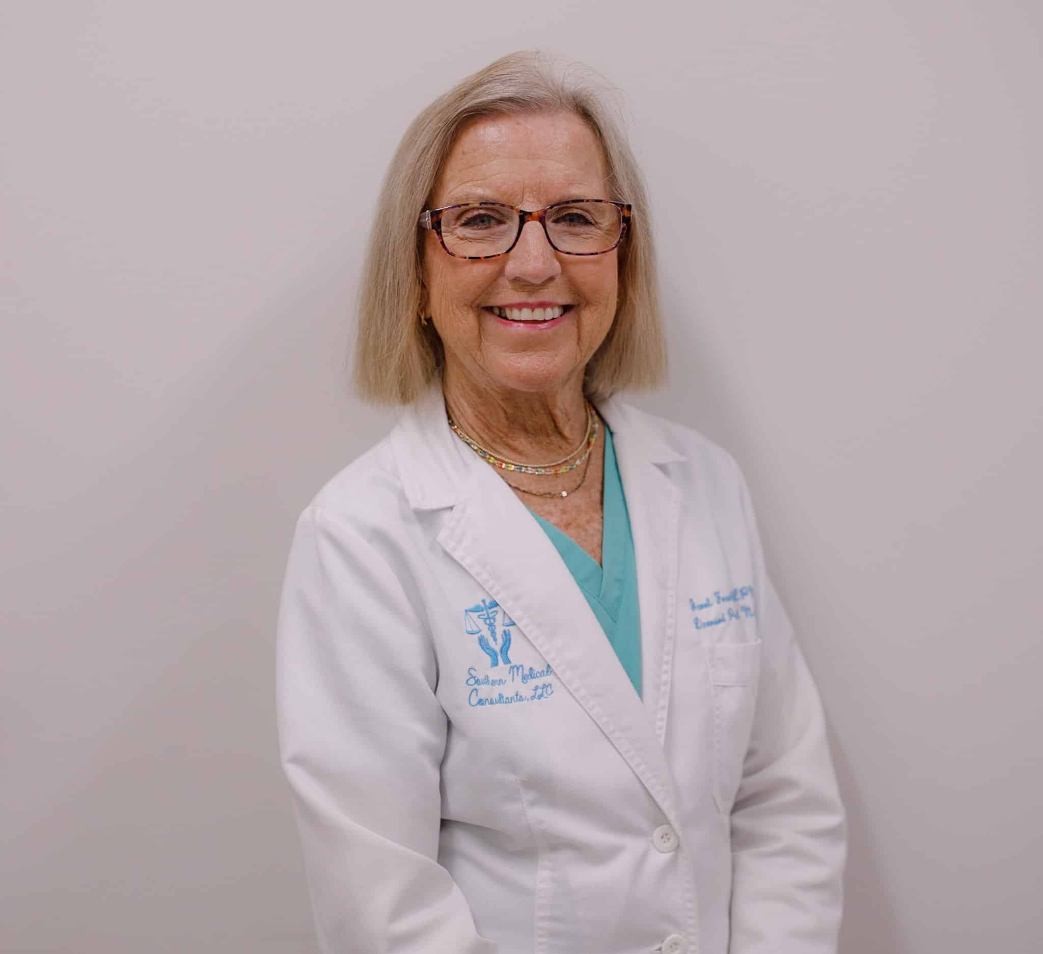 Smiling doctor in white coat and glasses