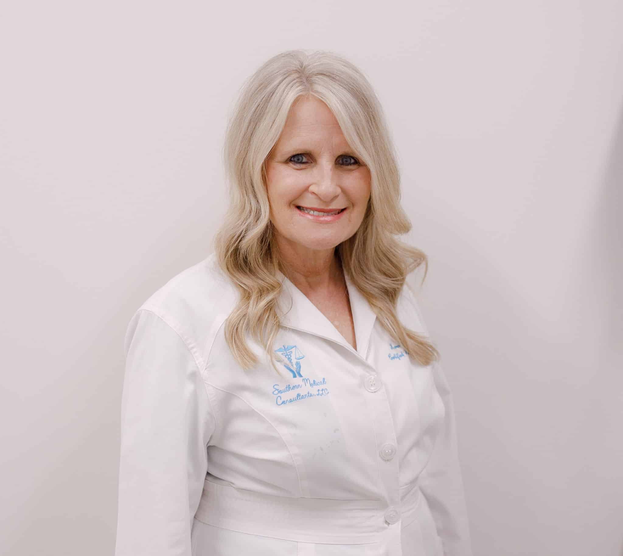 Smiling woman in a white lab coat