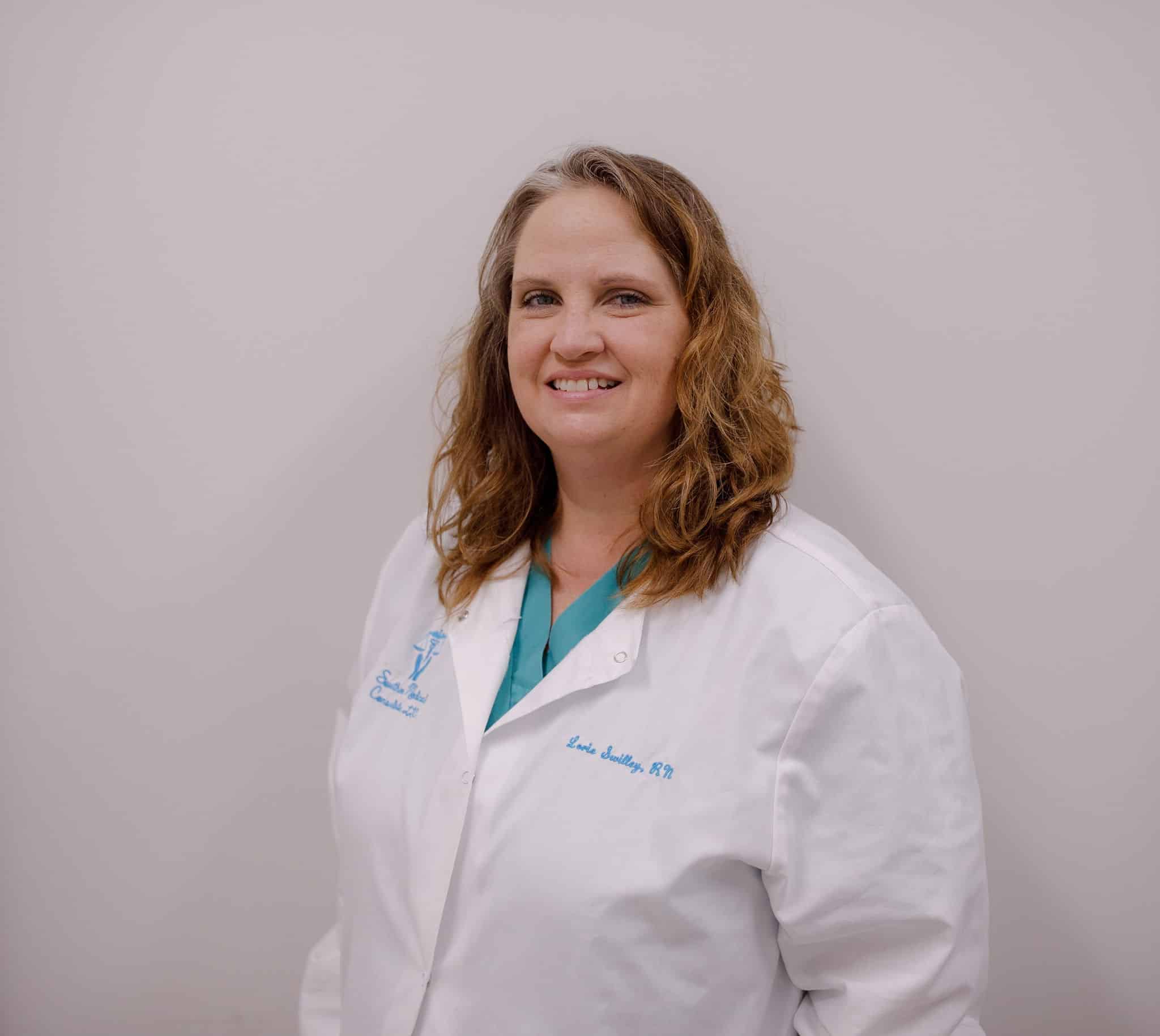 Smiling healthcare professional in white coat.