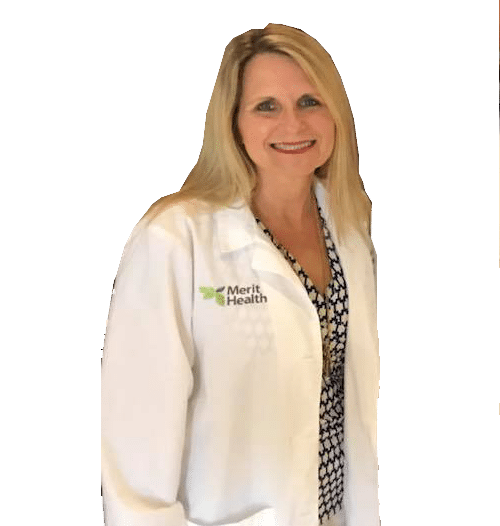Woman in white doctor's coat smiling.